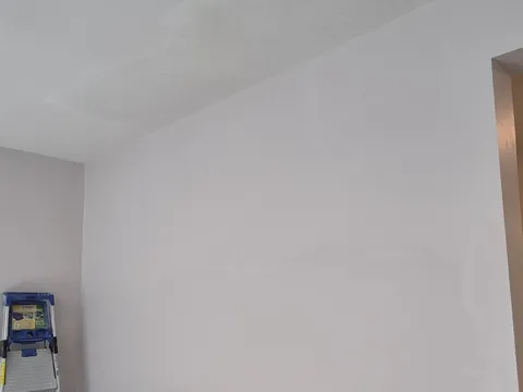 After: Same wall and ceiling fully patched, painted and textured with no holes visible