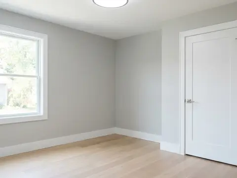 After: Freshly painted grey room with white trim